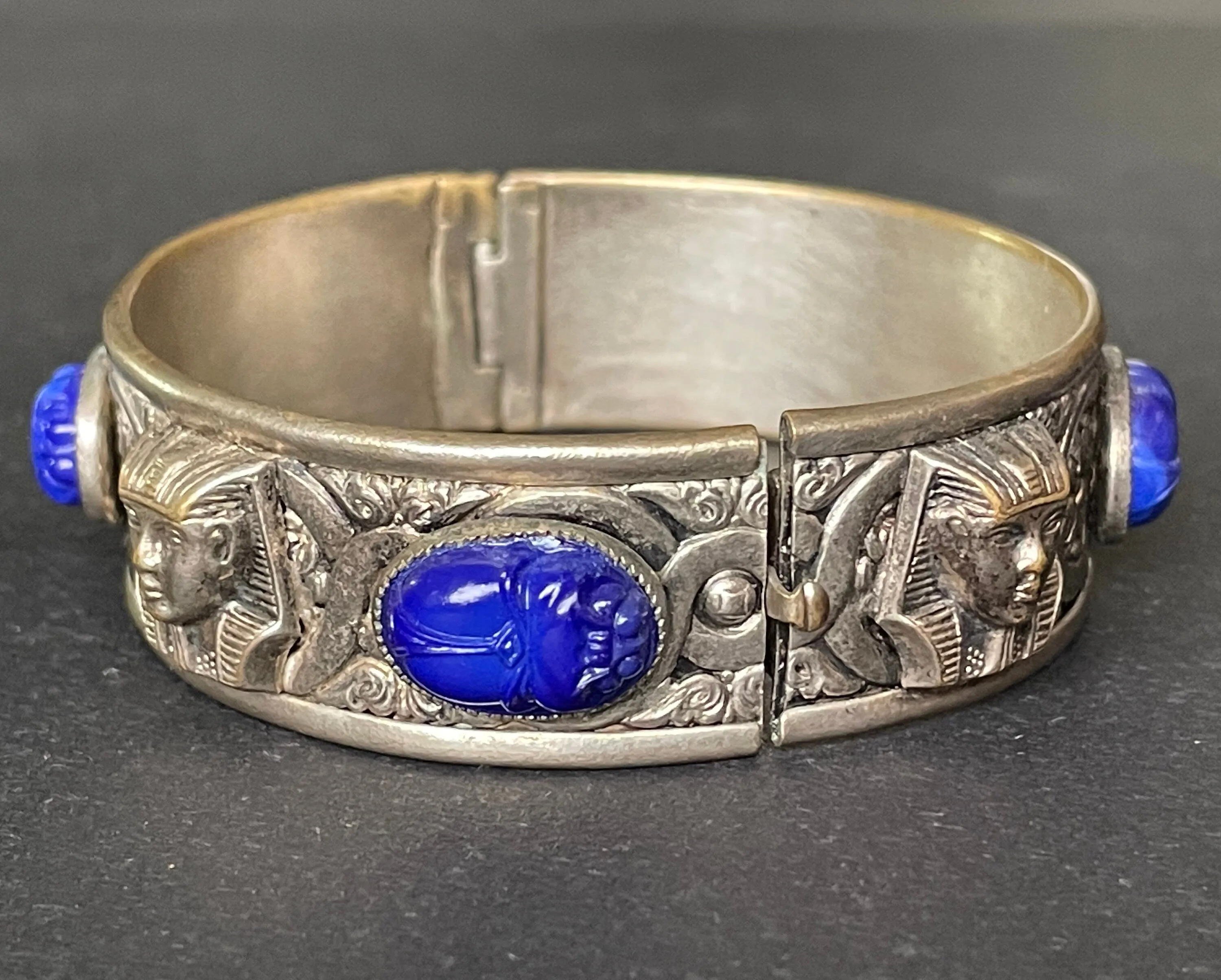 Vintage Egyptian revival Tutankhamun pharaoh and scarab beetle silver tone bangle, blue glass (faux lapis lazuli) scarab cabochons, Czech ?