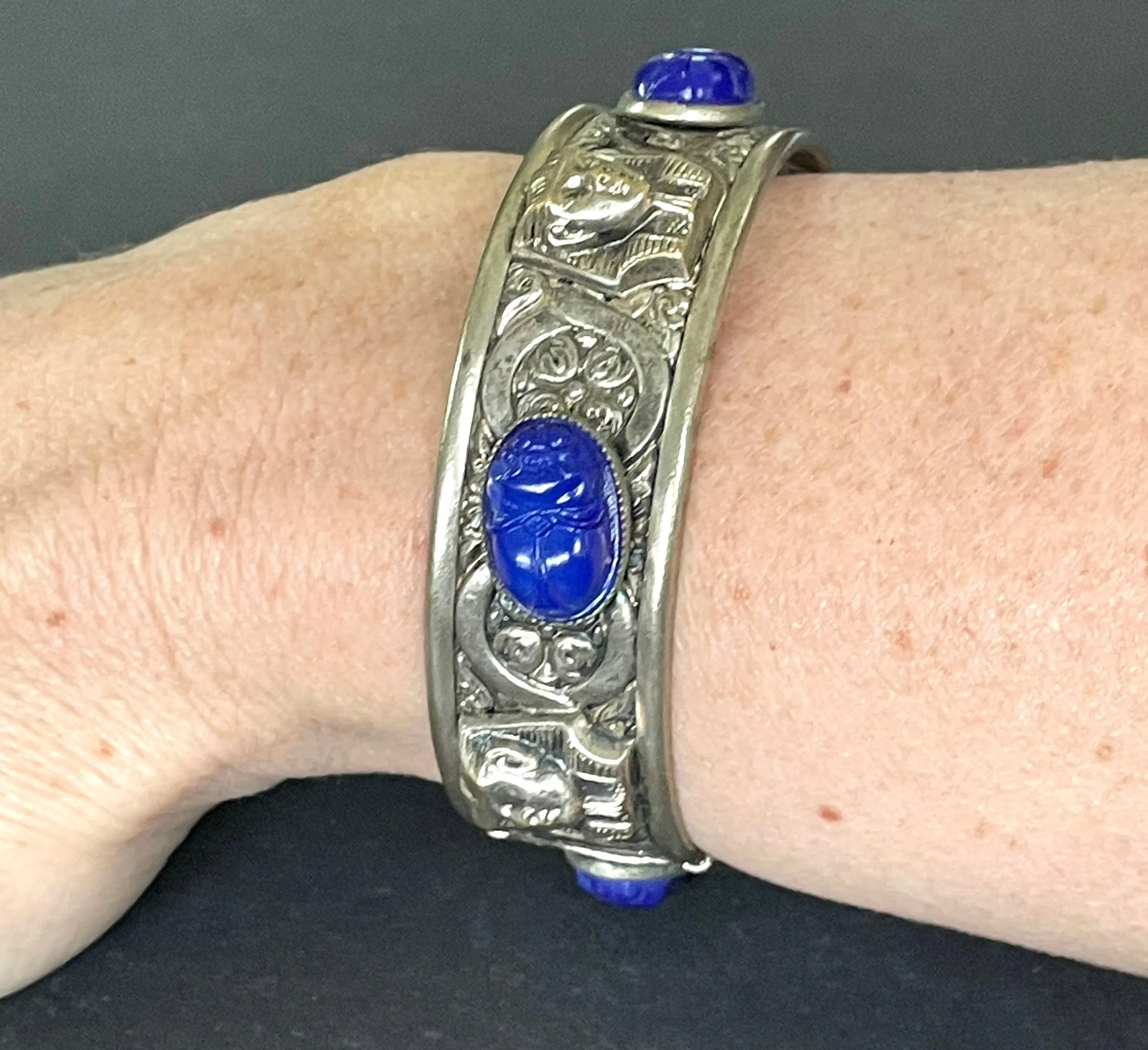 Vintage Egyptian revival Tutankhamun pharaoh and scarab beetle silver tone bangle, blue glass (faux lapis lazuli) scarab cabochons, Czech ?